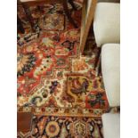 Large Persian style wool carpet, the brick red ground with large foliate medallion and spandrels,