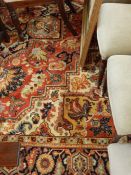 Large Persian style wool carpet, the brick red ground with large foliate medallion and spandrels,