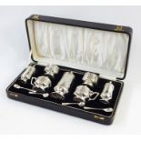 Early 20th century silver condiment set in black leather case, emblazoned with the initials 'F.J.