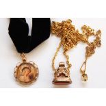 Antique gold plated fob set with cornelian type stone, with scroll mount, a gold-coloured metal