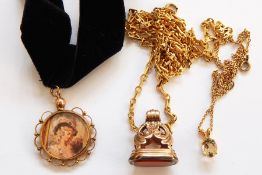 Antique gold plated fob set with cornelian type stone, with scroll mount, a gold-coloured metal
