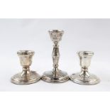 Pair of 20th century silver dumpy candlesticks and a single silver candlestick (3)