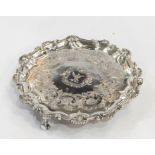 Small silver salver, circular with scallopshell and scroll raised border, the centre crest