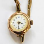 Lady's 9ct gold wristwatch with circular white enamel dial and the rolled gold strap and another