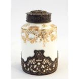 Victorian porcelain bodied jar with gilt decoration, white metal embossed lid with mask to the top