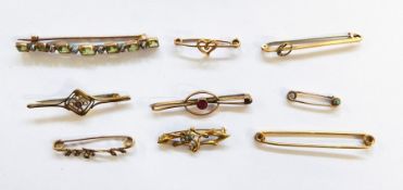 Nine assorted 9ct gold and yellow metal bar brooches and pins to include examples set with paste