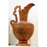 William Schiller & Sons Isnic-style pottery ewer, the red ground with green and gold incised