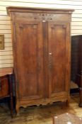 French fruitwood armoire with cavetto cornice, stylised floral carved frieze, the pair framed