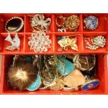 Quantity of costume jewellery brooches, bracelets, necklaces, etc, all within a red jewellery box