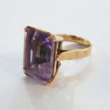 Gold and amethyst set ring, the large rectangular emerald cut amethyst 18mm x 14mm, 9.2g in total