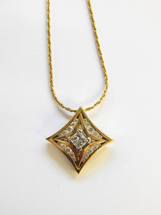 18ct gold and diamond star-shaped pendant on 18ct gold chain, the central princess cut diamond