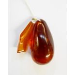 Large polished amber pendant, teardrop shape and another amber pendant (2)