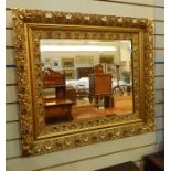 Ornate gilt wall mirror, pierced foliate border, approx 74 x 80 cm