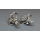 A pair of 1950's 18ct white gold and diamond earrings of bow design.