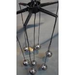 A seven chrome ball hanging light.