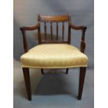 A Regency mahogany armchair with reeded arms and supports raised on tapered legs