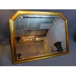 A giltwood overmantle mirror, having bevelled glass plate,