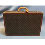 A vintage Louis Vuitton leather suitcase,