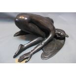 A 20th century cast bronze figural study of a kneeling lady with her hair draped on the floor,