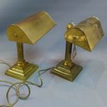 A pair of brass bankers lamps with Corinthium columns