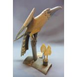 A 20th Century carved horn model of a bird of prey raised on horn stand,