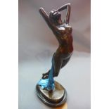 A cast bronze figural study of a nude lady with draping turquoise robe, raised on oval marble base,