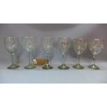 Six late 19th/early 20th Century glasses having etched floral decoration, pontil marks to bases.