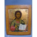 A Russian icon depicting Christ Pantocrator, tempera on wooden panel and parcel gilded,