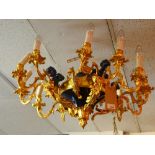 WITHDRAWN-An 18th Century style bronze and ormolu twelve branch chandelier decorated with putti.