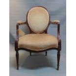 A Victorian mahogany balloon back armchair with marquetry inlay raised on reeded legs