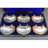 A cased set of six silver kidney shaped condiment clips, by A.