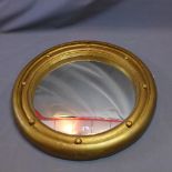 A large convex circular giltwood mirror,