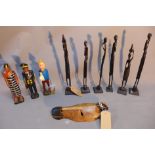 A collection of African carved wooden figures, to include three painted figures of Tintin, a pilot