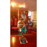 A 20th Century cast bronze statue of a female tribal warrior in traditional dress. H-81cm