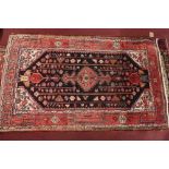 A fine North West Persian Koliahee rug with central diamond medallion on a midnight field within