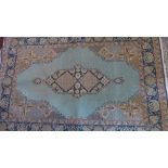 A Qum part silk rug with central lozenge medallion on a blue ground contained by many floral