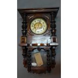 A early 20th century mahogany wall clock by Gustav Becker, the case with turned pillars and carved