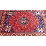 A fine south west Persian Qashqai carpet with central medallion with repeating animal motifs on a