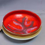 A Poole Pottery red ground bowl. D.27cm