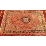 A North West Persian carpet with central floral medallion surrounded by repeating floral motifs