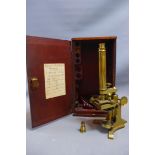 A 20th century brass microscope, with glass slides, microscopic glass square and a W.F. Durroch