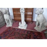 A pair of reconstituted stone dogs