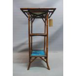 A Victorian bamboo three tier jardiniere stand set with Minton tiles depicting hunting scences