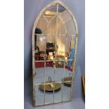 A large arch top garden mirror