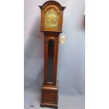 An early 20th century oak longcase clock, the broken arch brass dial with Roman numerals, the case