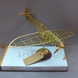 A Bigwing Spitfire brass airframe kit, the brass frame on pivotal ball joint, raised on circular