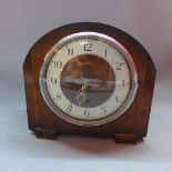 An Enfield oak mantle clock, the silvered chapter ring with Arabic numerals, the plain oak case