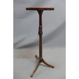 A late 19th century mahogany lamp stand with reeded support raised on three splayed legs. H-90cm