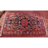 A fine North West Persian Nahavand rug, having designs on a deep midnight blue field surrounded by