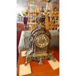 A late 19th century French bronze mantle clock, drum movement, the dial with enamel Roman